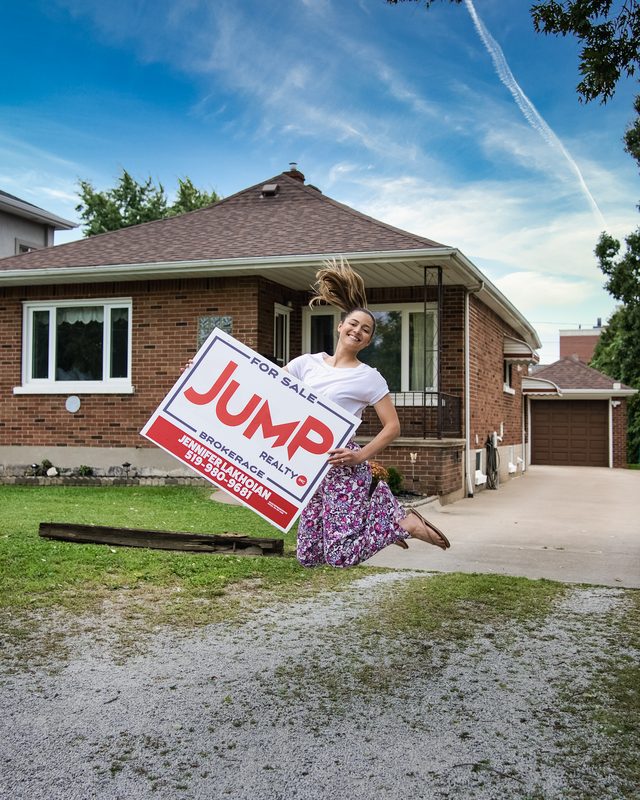 Agent jumping with JUMP Realty sign — Coming Soon brand photo