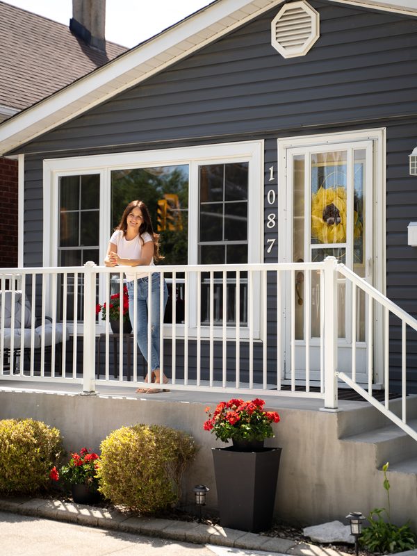 Agent on front porch of listing — Coming Soon brand photo