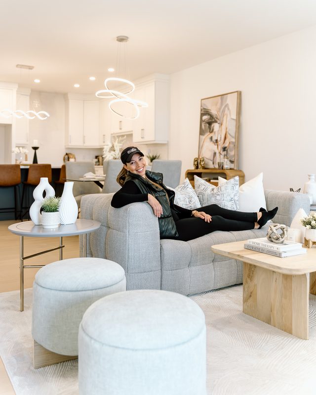 Agent lounging in staged living room — Coming Soon brand photo