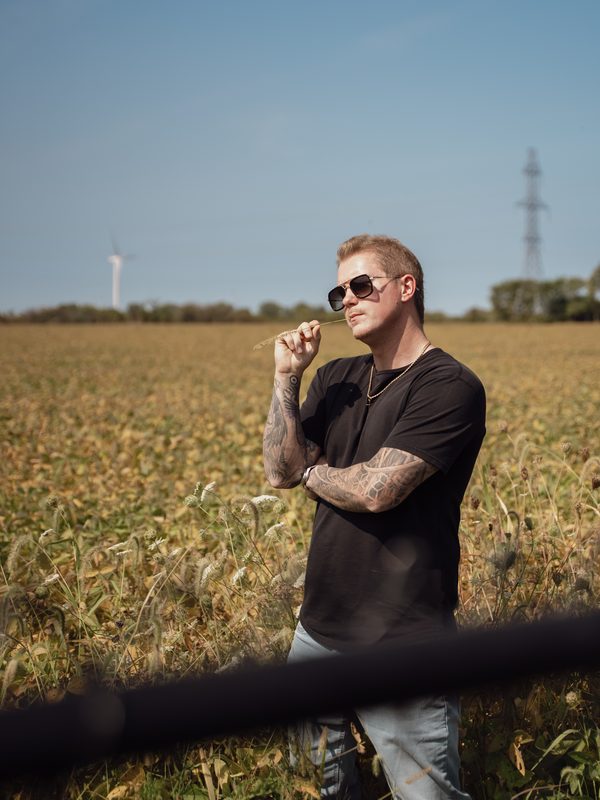 Agent portrait in rural field — Coming Soon brand photo