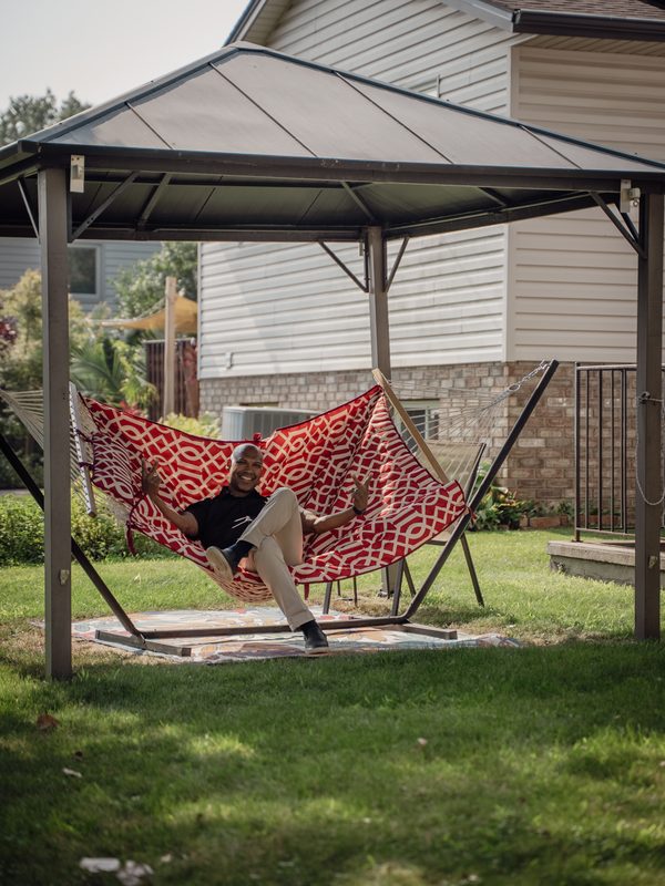 Agent relaxing in hammock at listing — Coming Soon brand photo